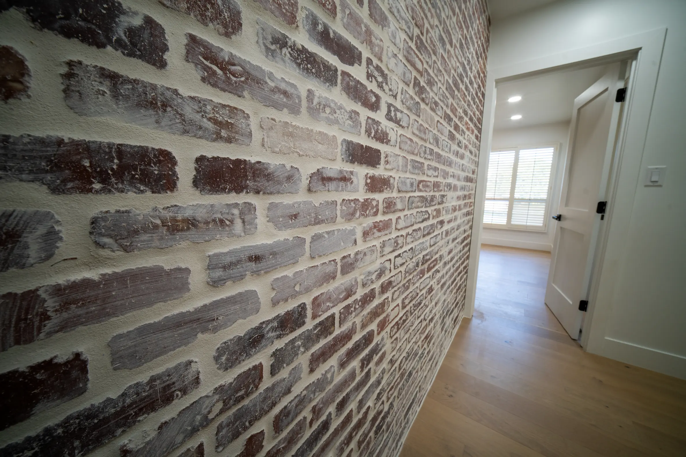 Brick accent wall in a hallway on a Masizo remodel