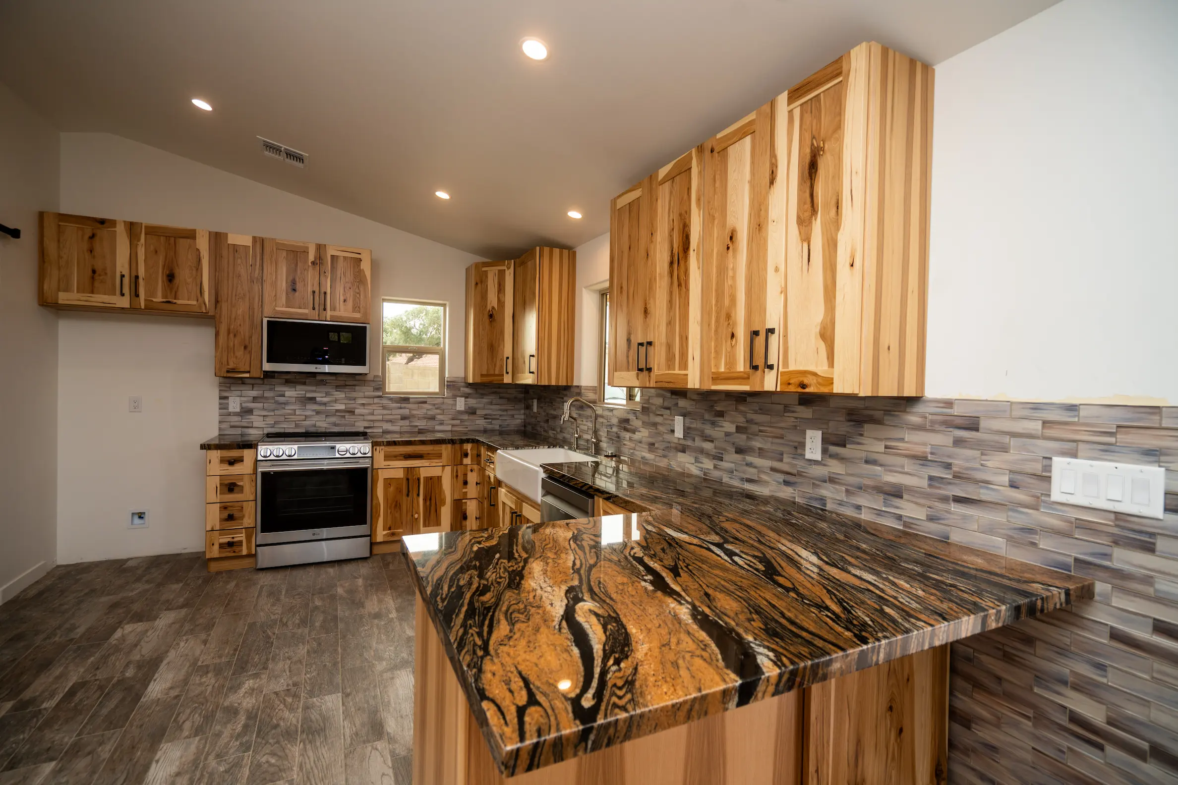 Hickory kitchen with a granite island on a Masizo job