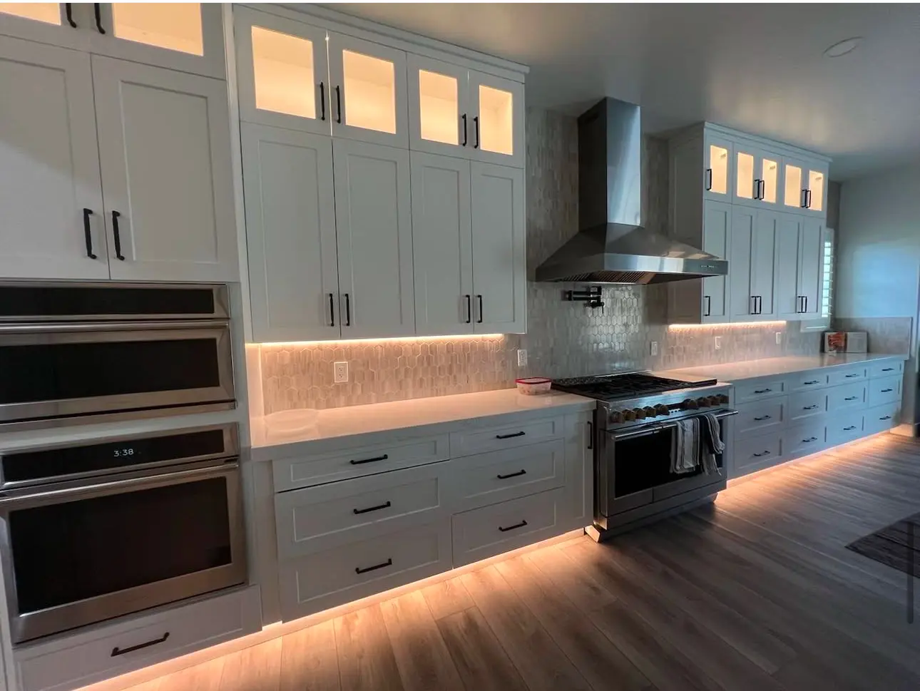 White kitchen with under-cabinet lights on a Masizo remodel