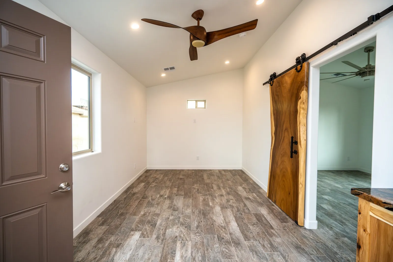 Finished room with a wood barn door on a Masizo job