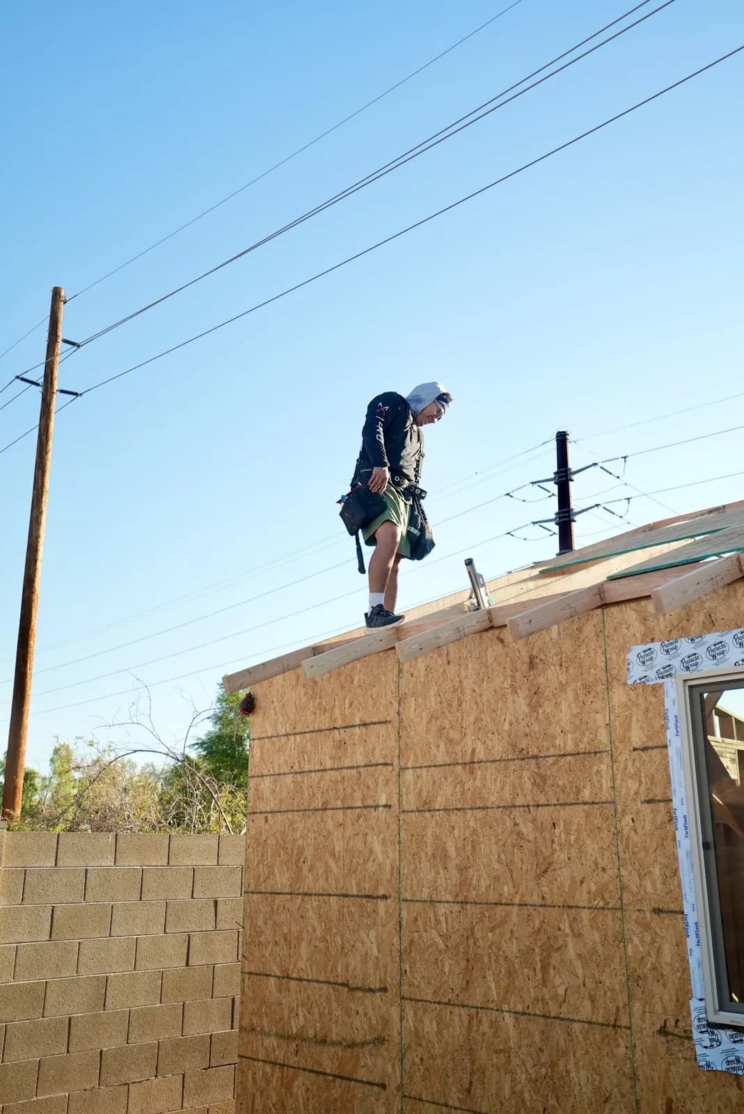 Masizo crew member working on a roof