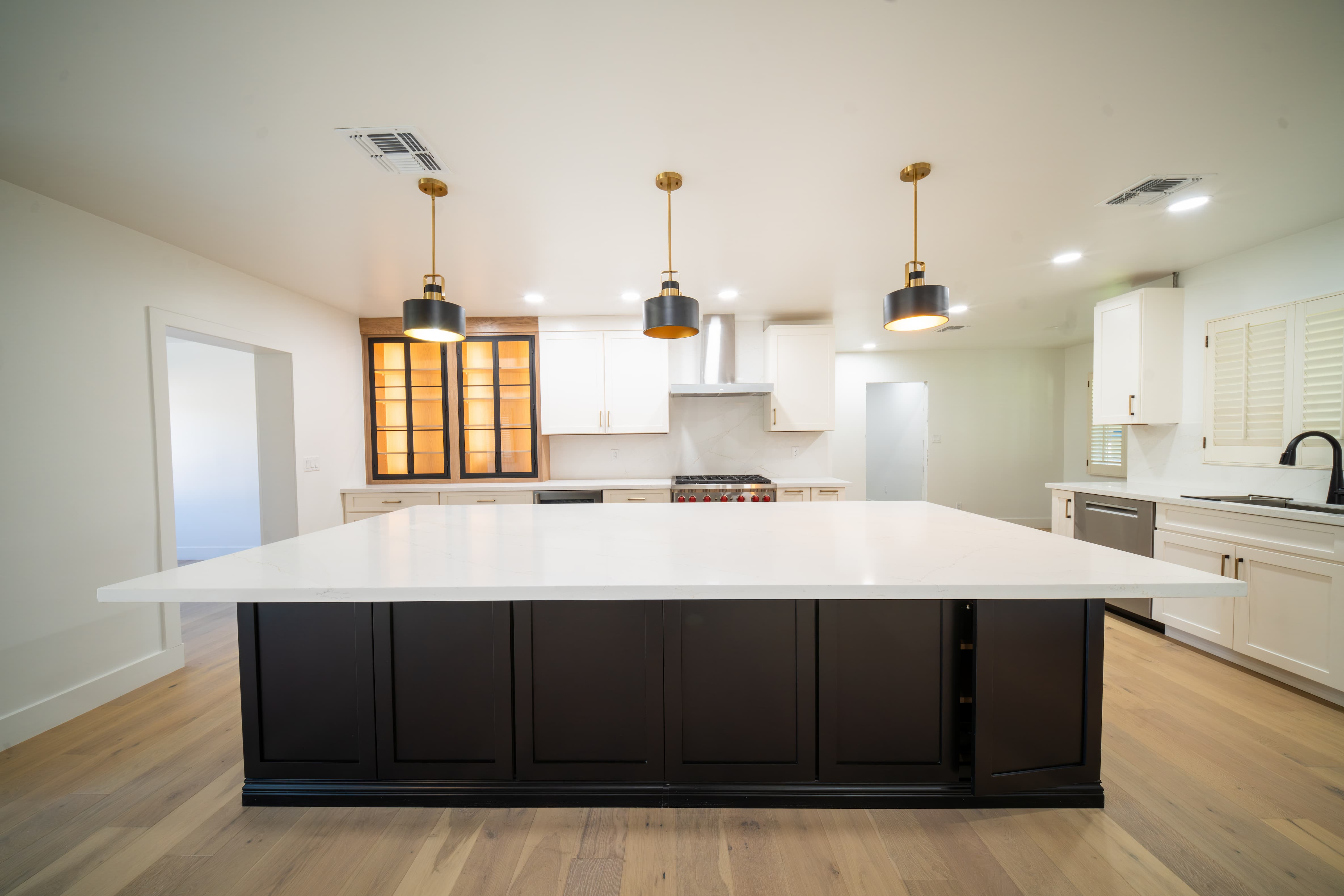 Kitchen remodel with a large quartz island and pendant lights