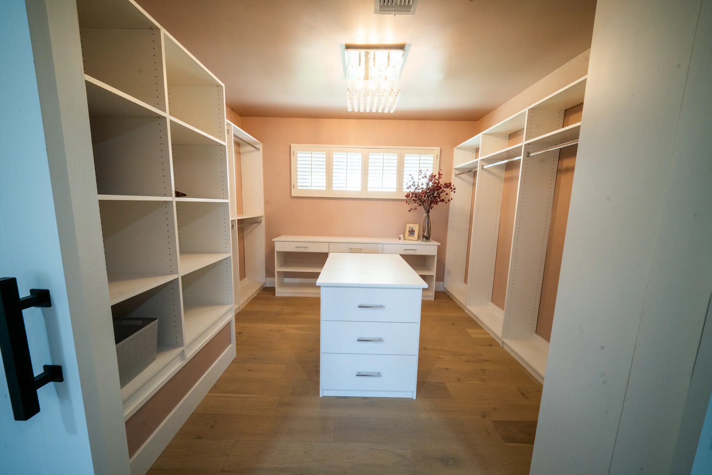 Walk-in closet with built-in shelving and a center island