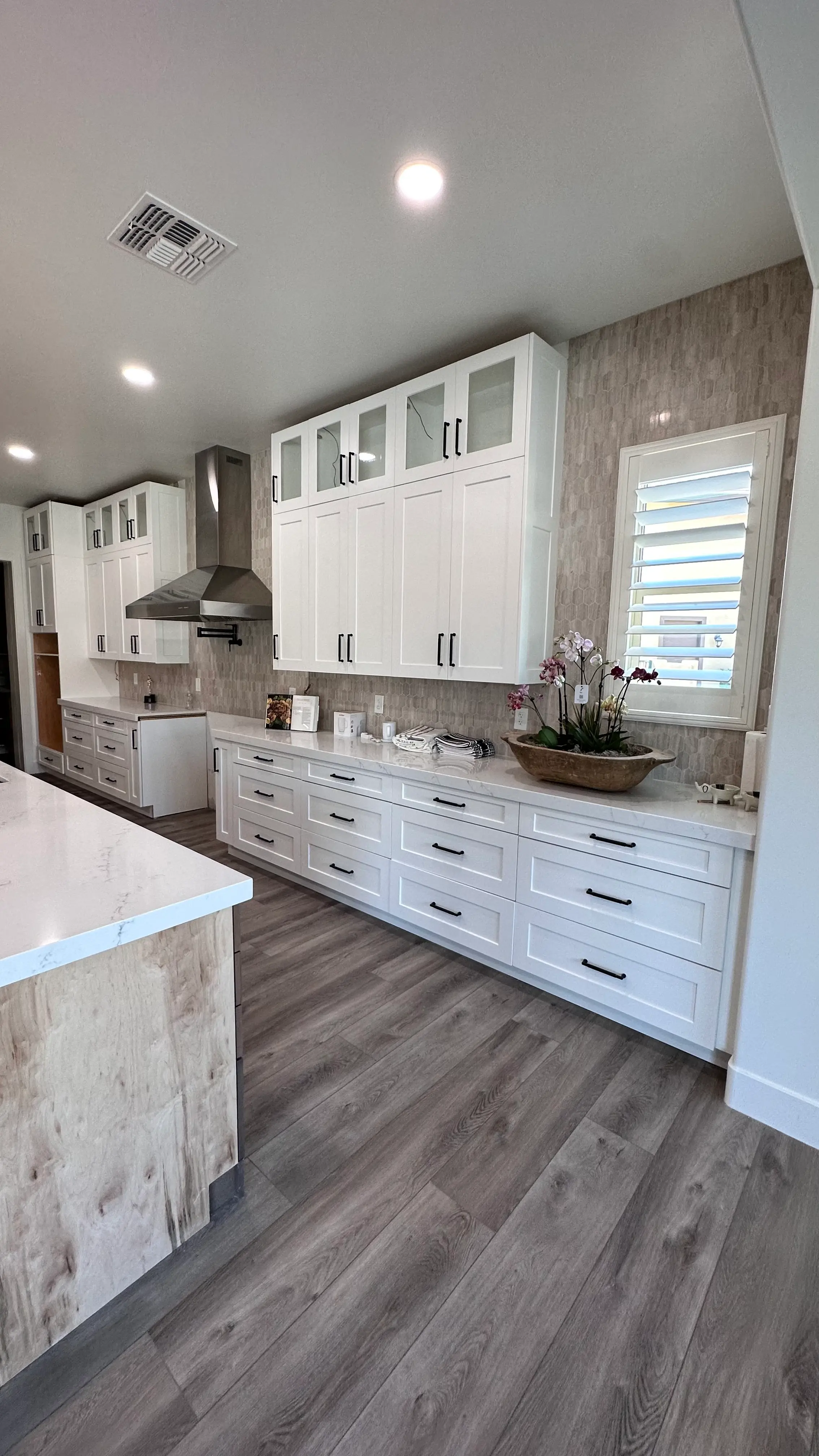 White kitchen cabinets with glass-front uppers