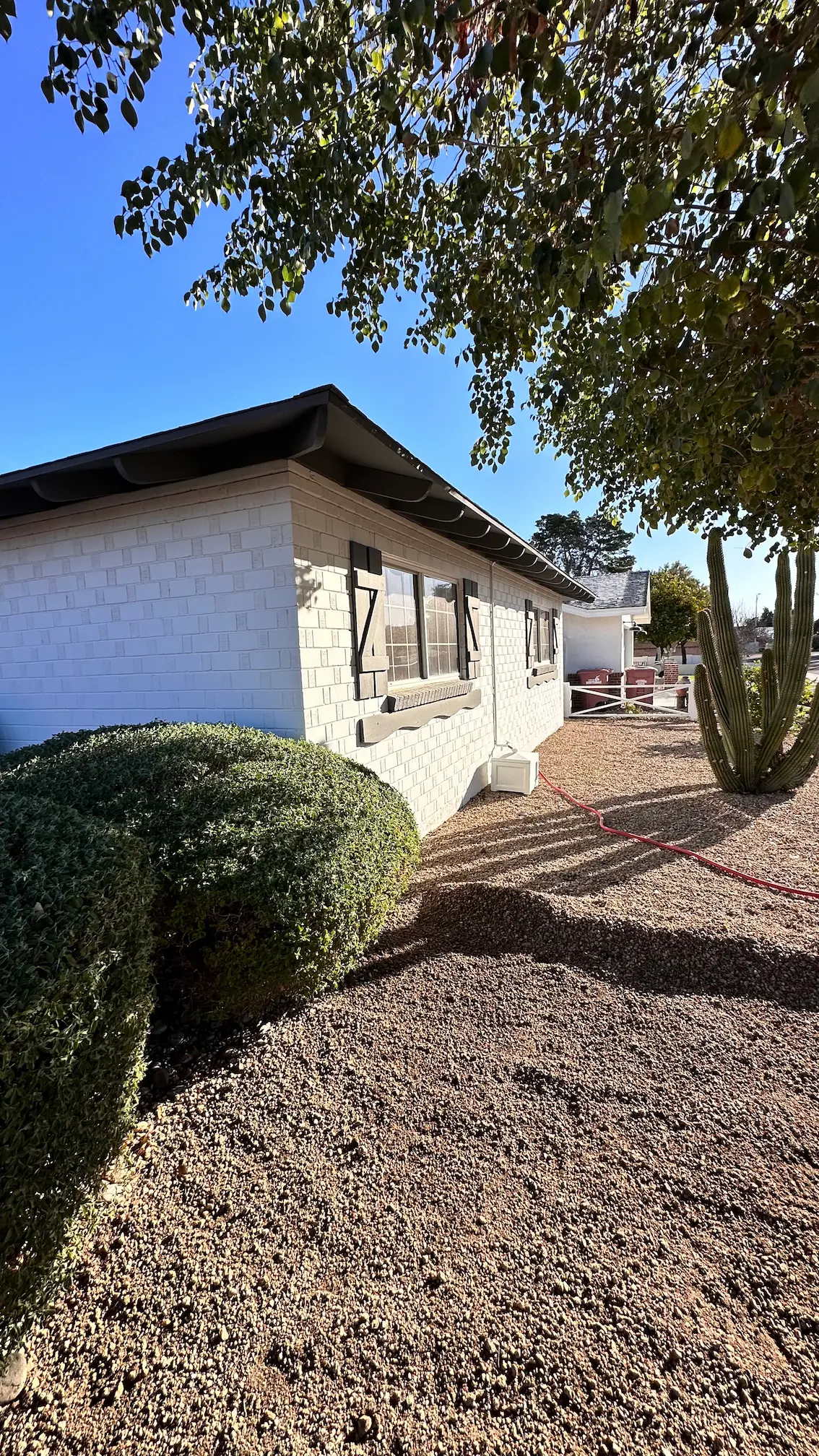 Side of a renovated home with fresh desert landscaping